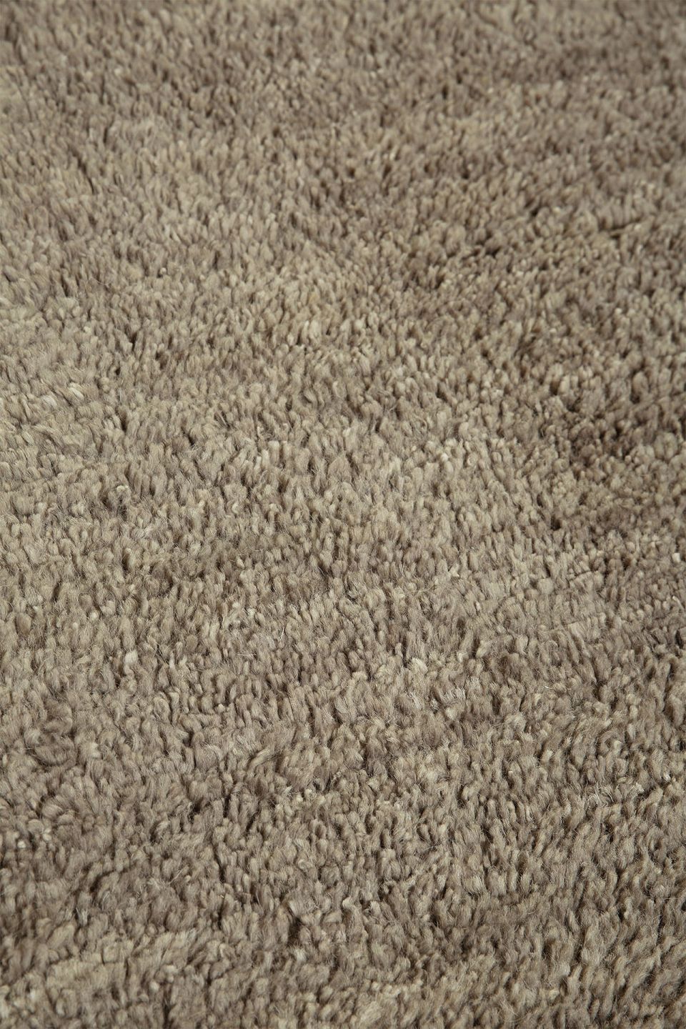 Detailaufnahme des Ethnicraft Dunes Teppichs in Cumin, ein hochwertiger, beiger Wollteppich.