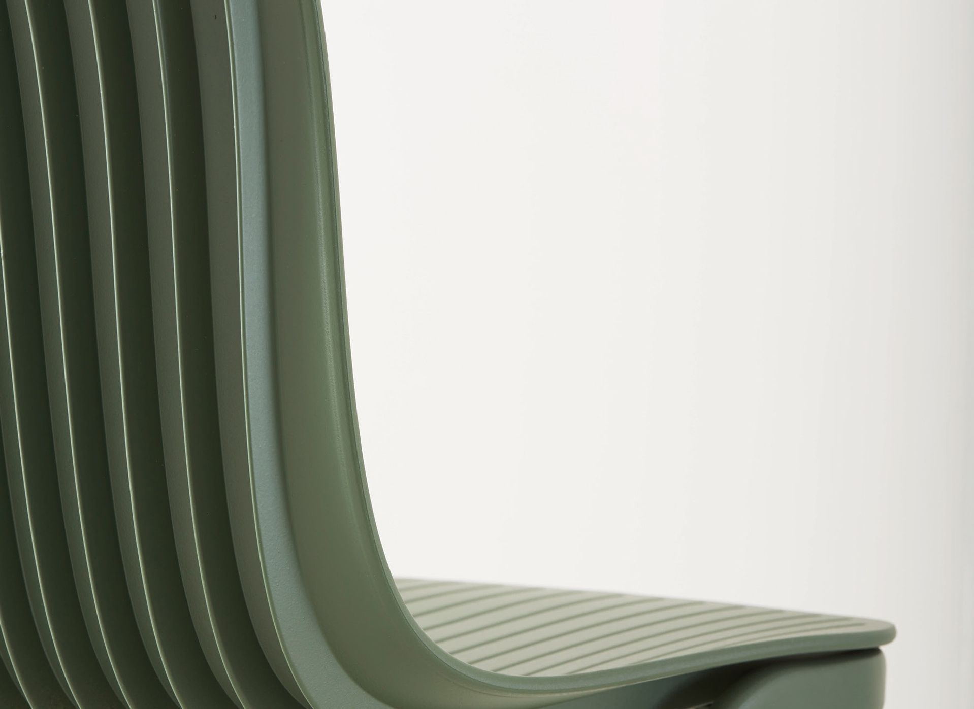 Detailaufnahme: Grüner Dragonfly Stuhl von Segis mit Kufengestell, ohne Armlehnen. Designstuhl für Büro und Wohnbereich.